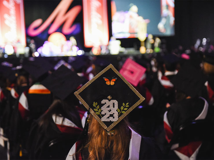 The cap of a graduate is decorated to read 