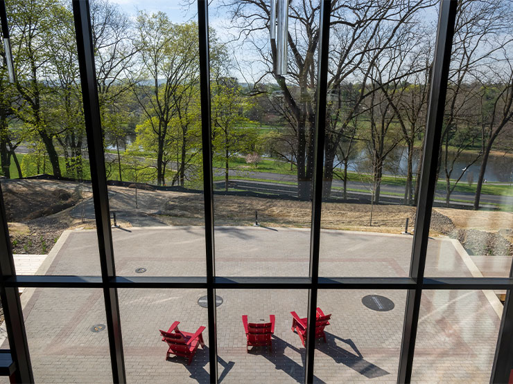 A view of large, clear windows with markings that make them visible to birds.