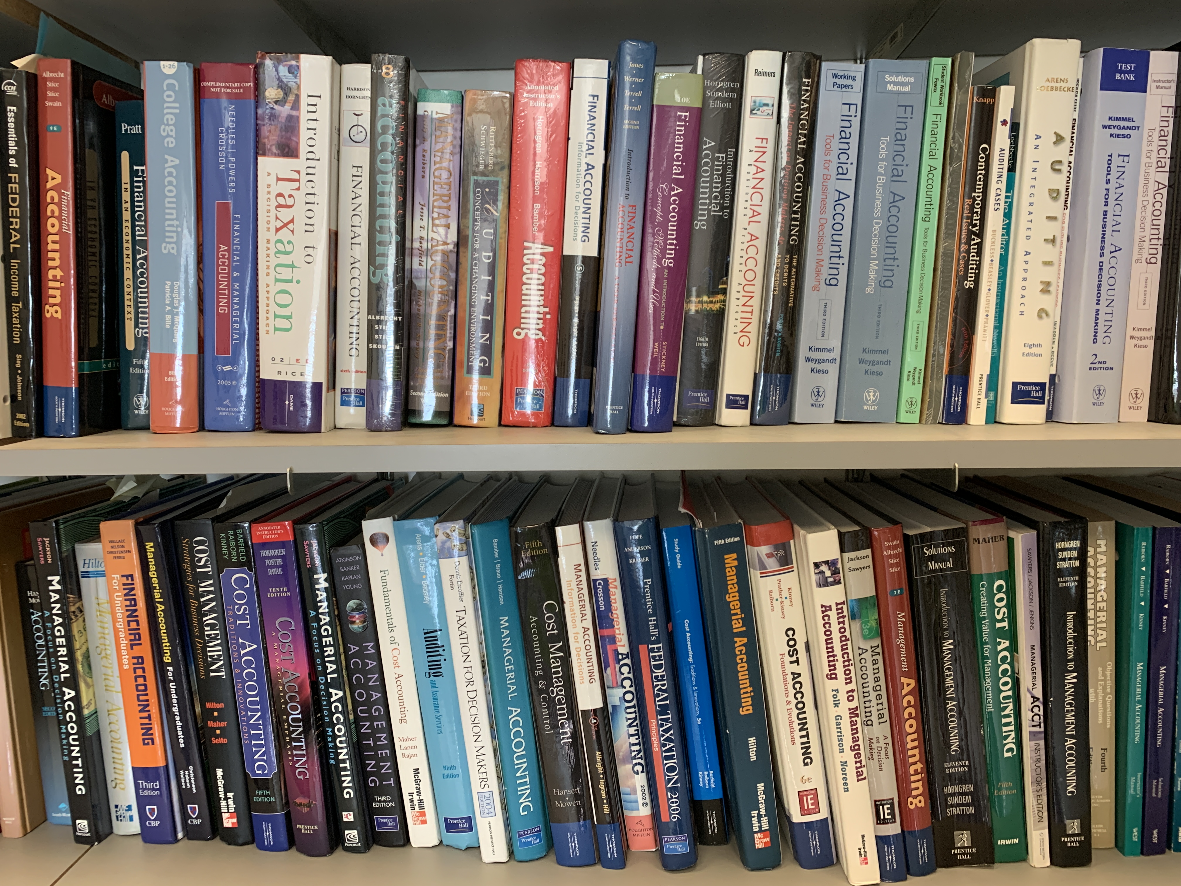 A bookshelf is packed with books of various sizes and colors.