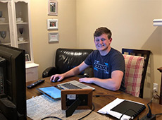 Student seated at a computer desk