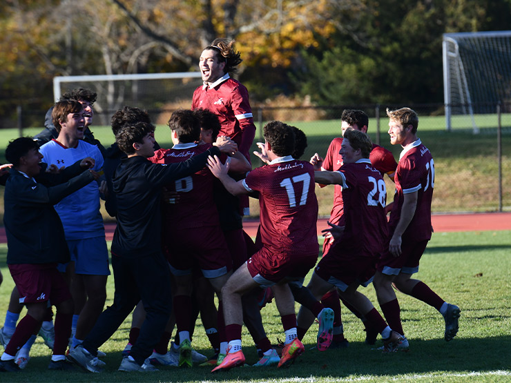 The Muhlenberg men's soccer team celebrates.