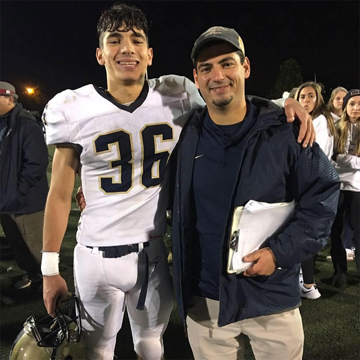 Family posing for photo at a football game