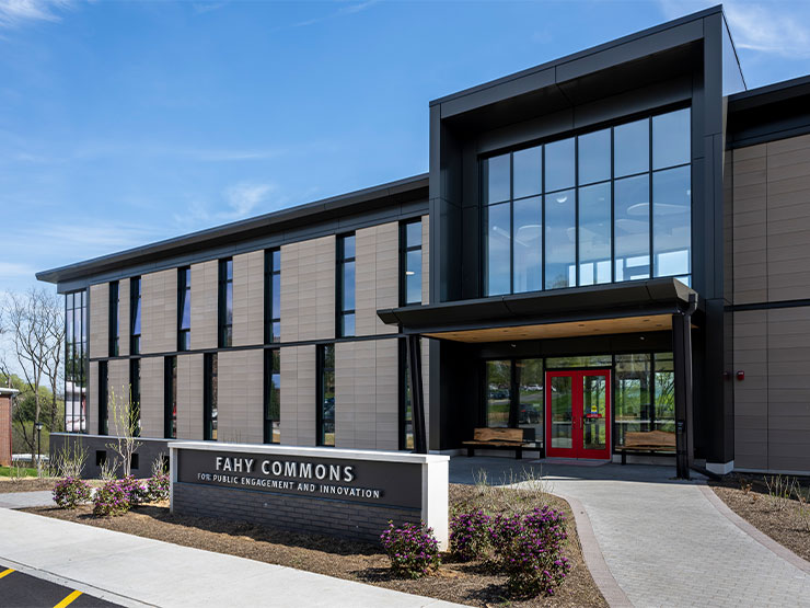 The Fahy Commons for Public Engagement and Innovation stands against a blue spring sky.