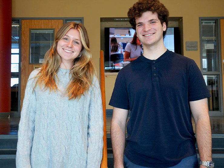 Muhlenberg friends Yana Zelinsky and Zachary Cohen-Neamie stand side-by-side on an indoor campus stairway.
