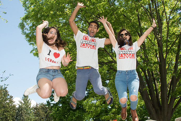 Student leaping into the air in joyous fashion.