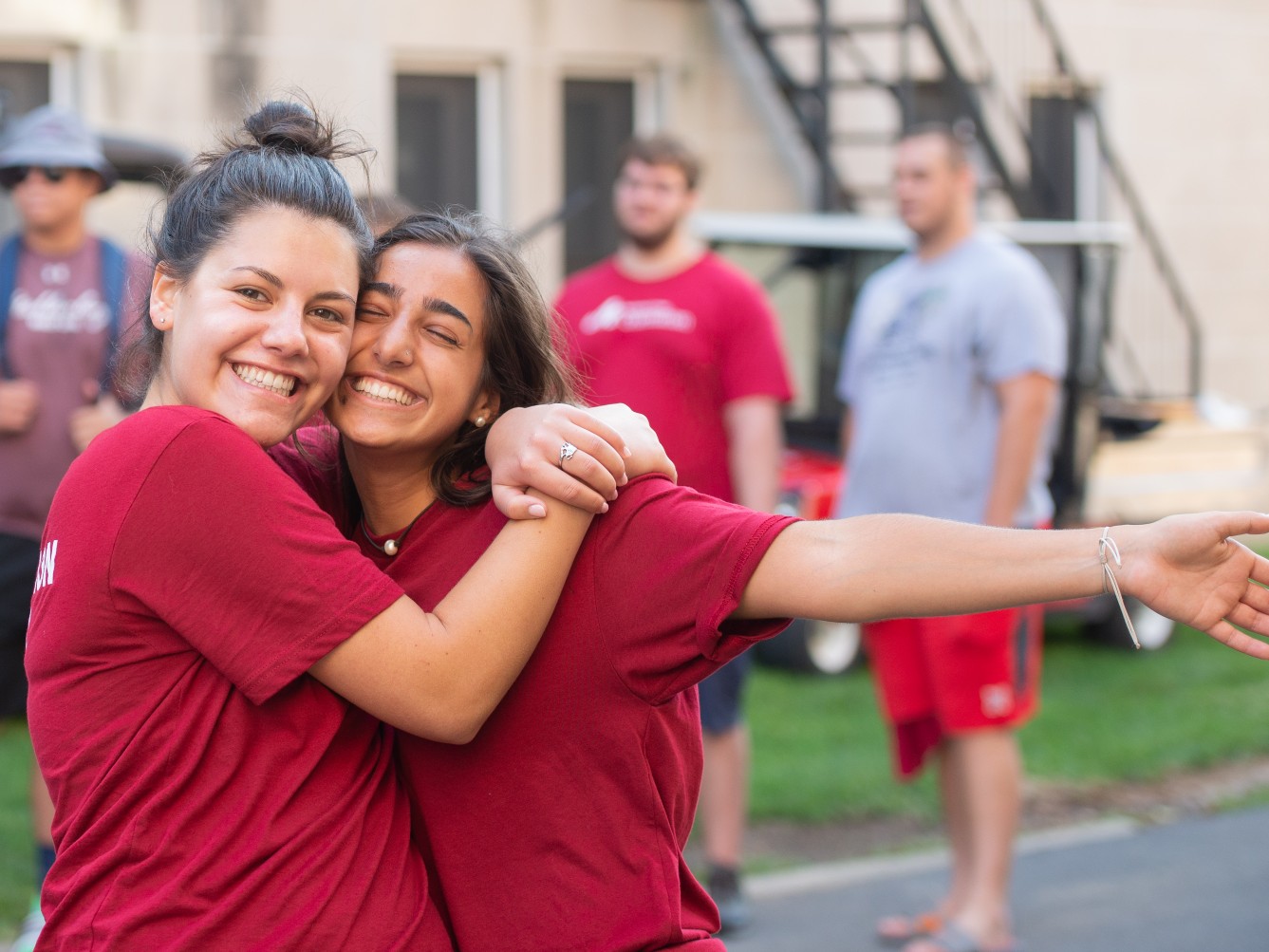 Students embrace during residence hall move-in.