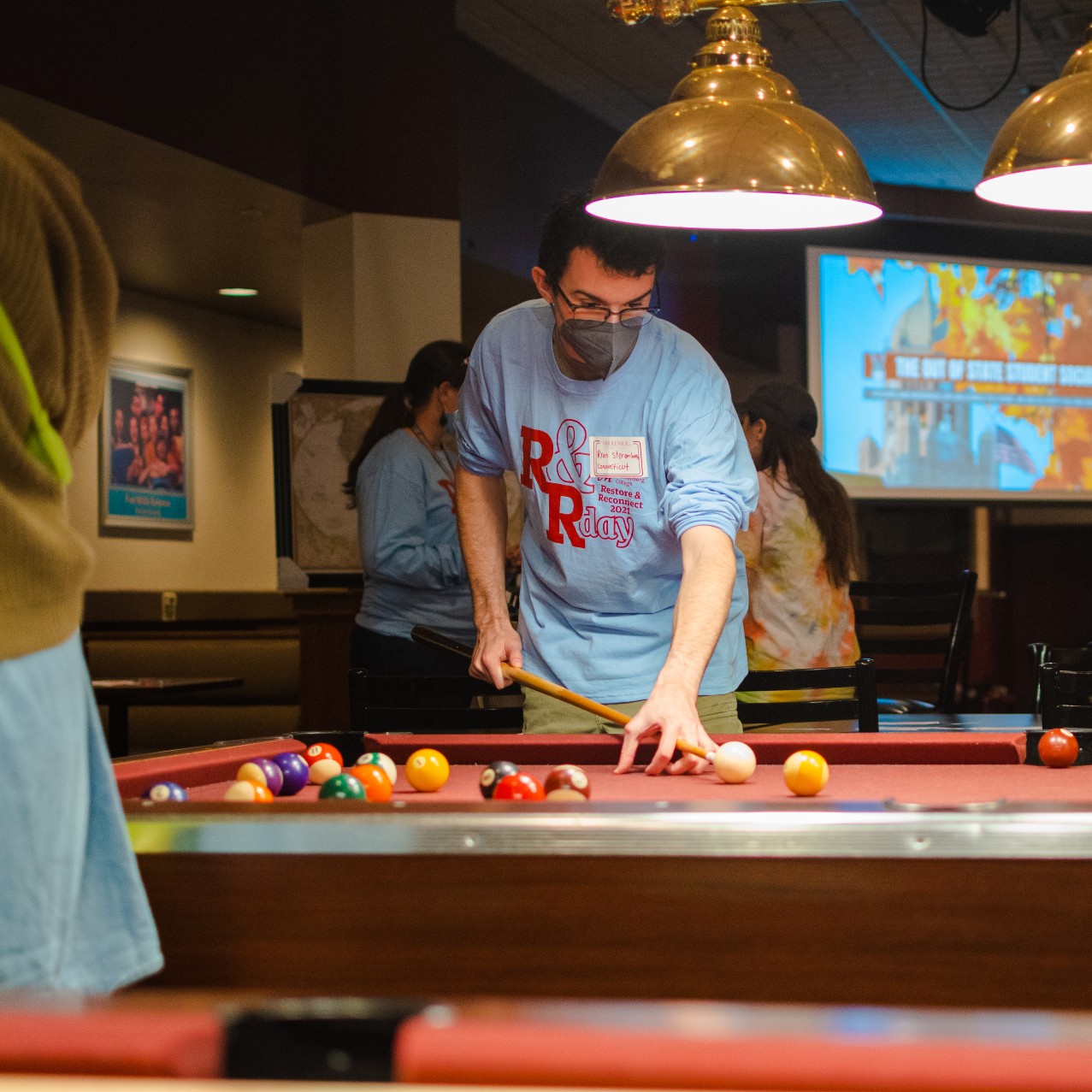 A student plays pool during the Out of State Social event sponsored by the Office of Housing and Residential Life.