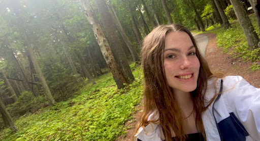 Headshot of a student on a forest path