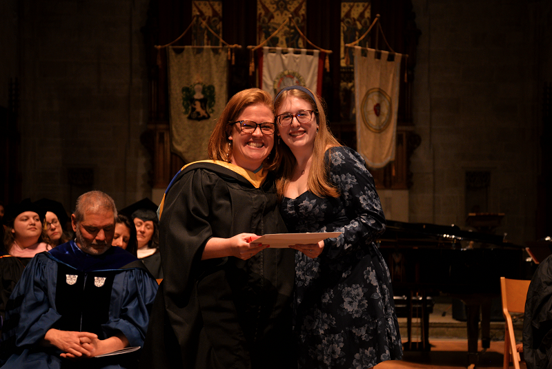 two women posing at honors convocation
