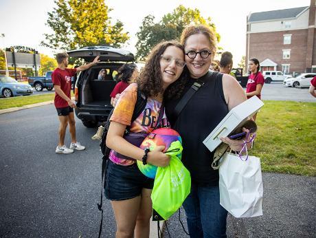 Student move-in day with student and family members.