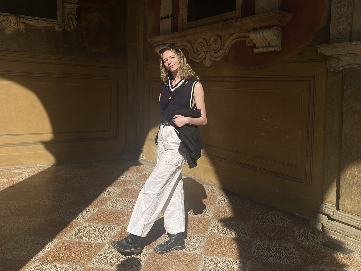 A college student stands in a sunbeam