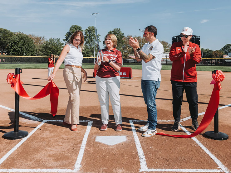 Muhlenberg College President Kathleen Harring smiles after a ribbon cutting ceremony with dignitaries at a new college ball field.