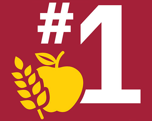 A white numeral one with a number sign against a red background with a yellow apple and wheat illustration.