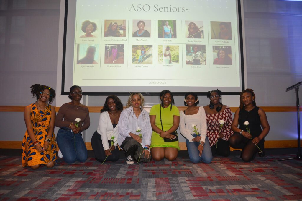 A group of college students kneels in front of a screen that says ASO Seniors