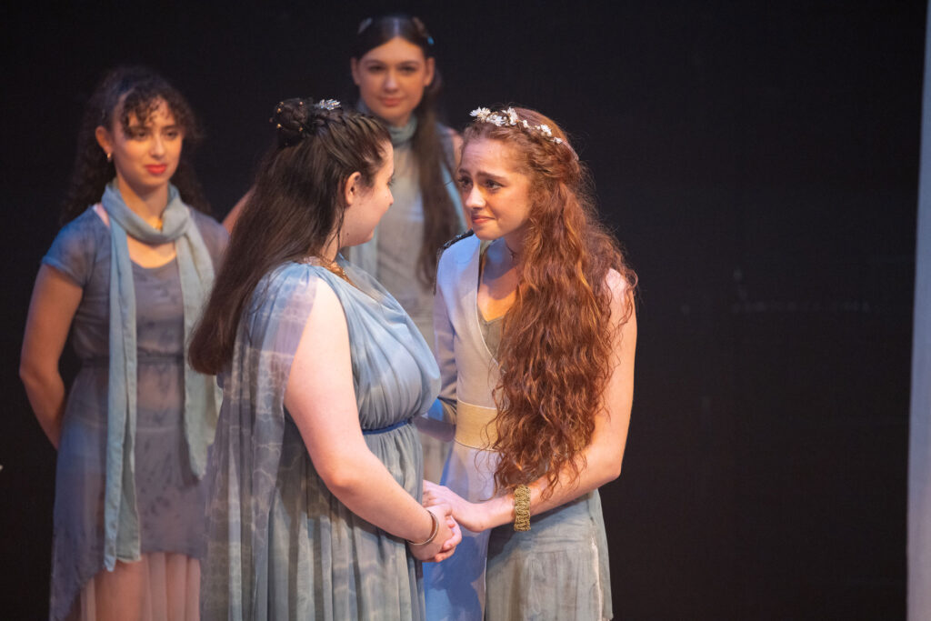 Two college students in costume on stage