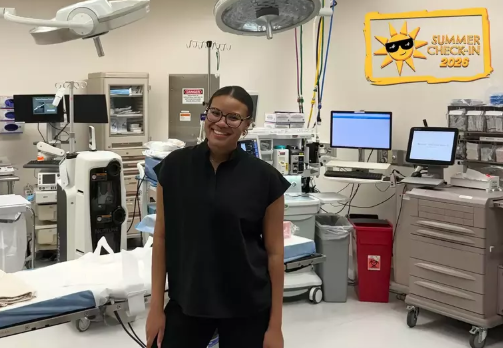 Andrea Romero-Agosto stands in patient care room