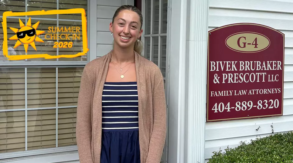 Ansley Asche in front of law firm sign