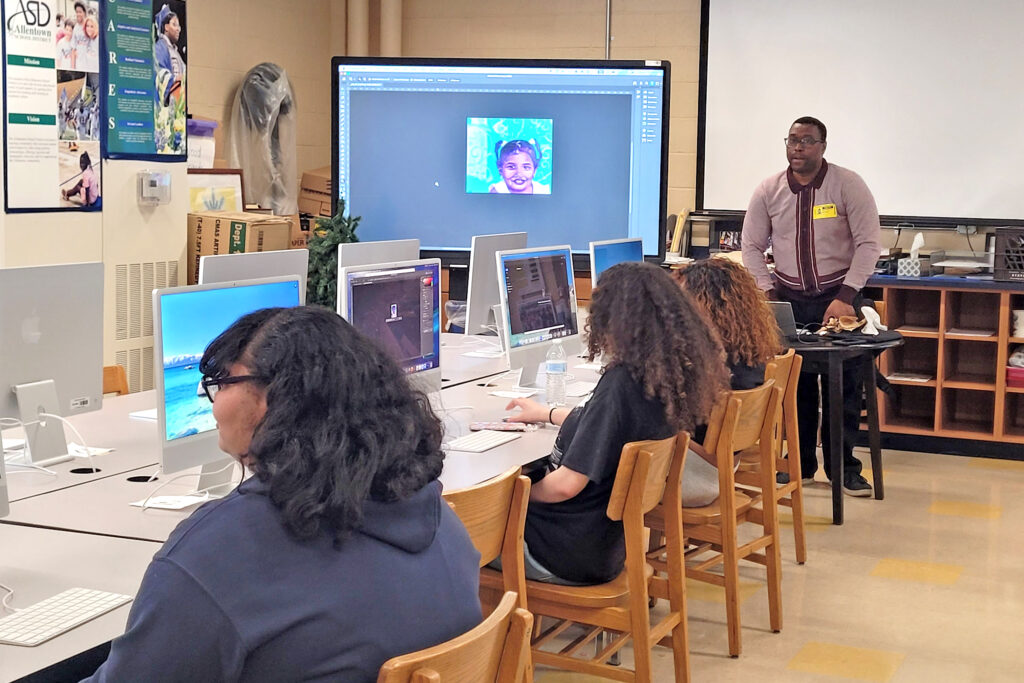 A college professor helps high school students with Photoshop