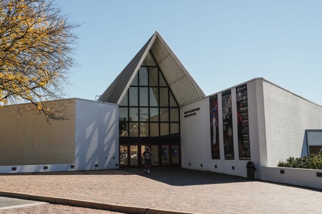 A large white brick academic building with a pointy roof