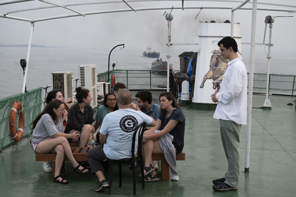 Students and teachers sit in a group