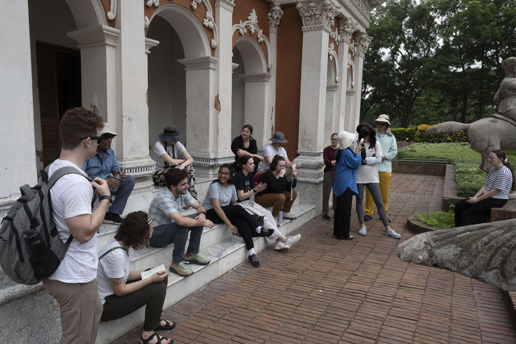 Students sit on a step in Bangladesh