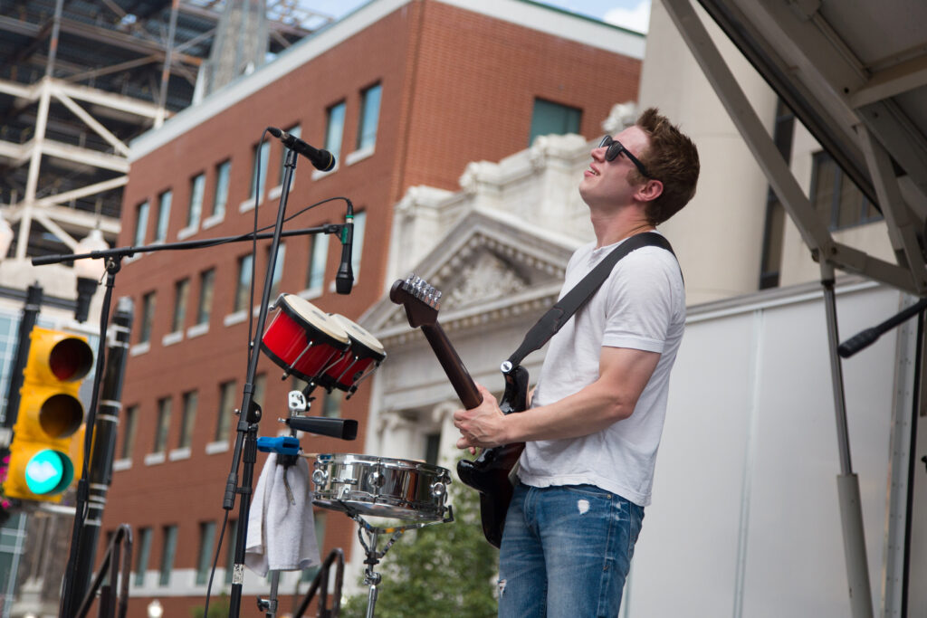 Photo of a musician onstage playing guitar