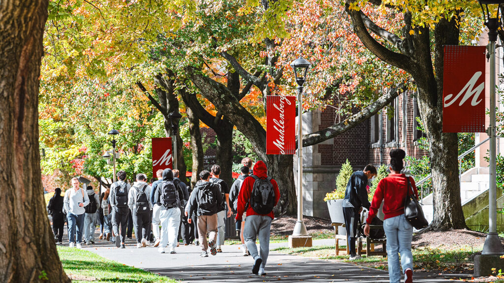 students walk on academic row path