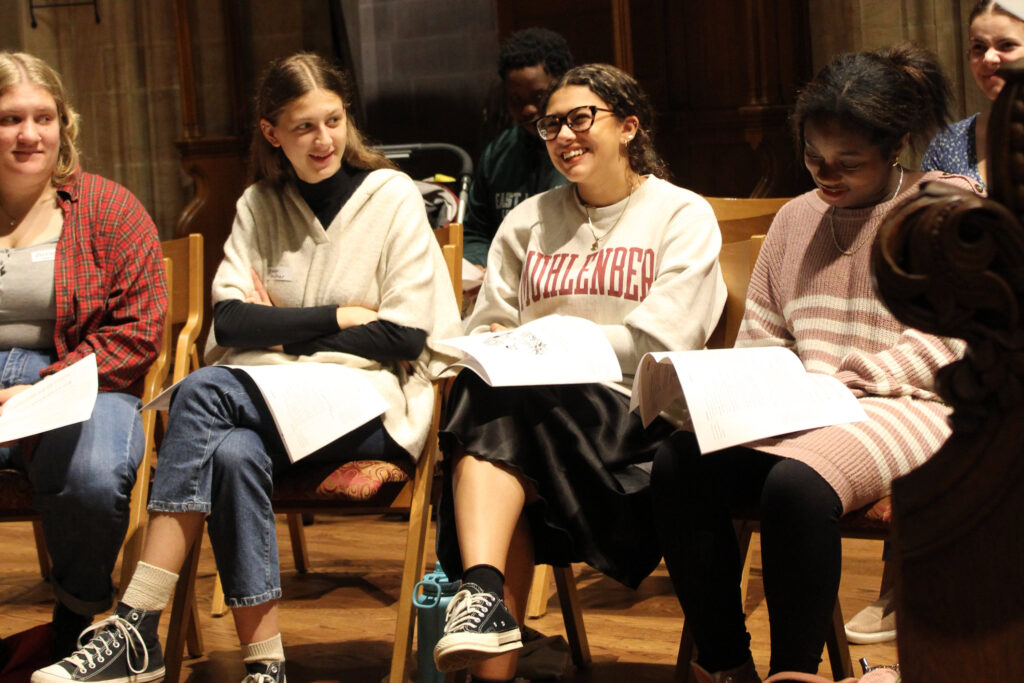 Four college students sit together in a chapel