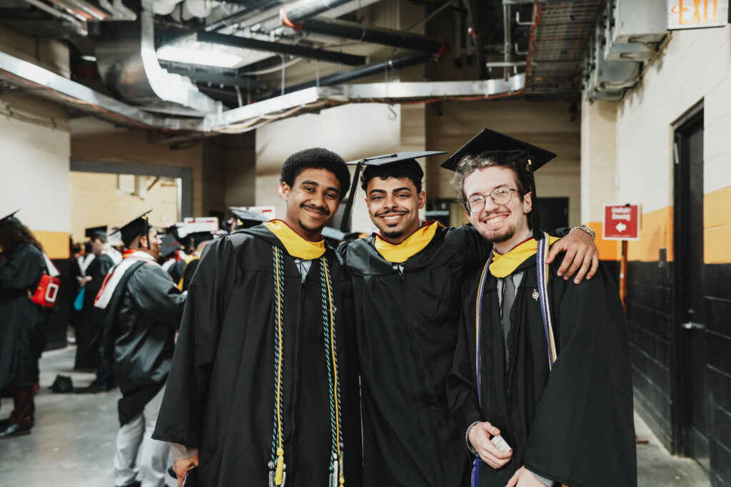 Three college graduates before commencement