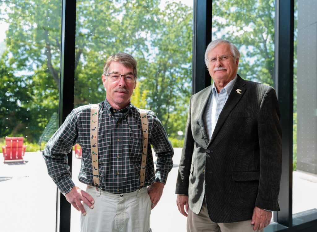 Ornithological Specialist Peter G. Saenger and Professor Daniel Klem stand near the windows of Muhlenberg College's Fahy Commons, which feature bird-friendly glass coating.