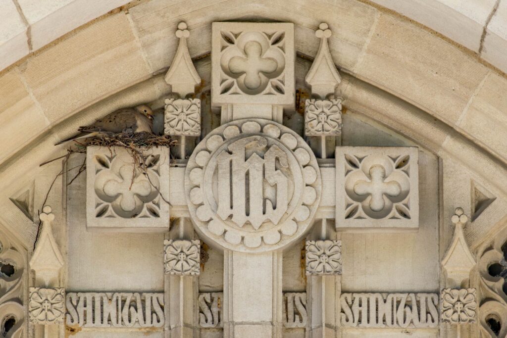 An intricately carved cross above the entrance to Egner Chapel.