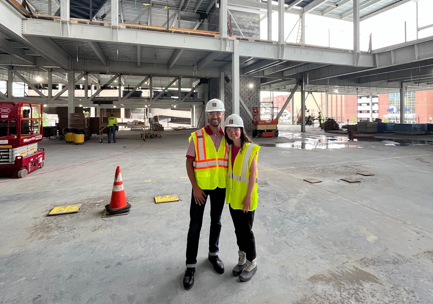 Two people stand in construction attire