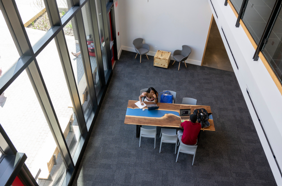 Looking down from balcony on table and windows.