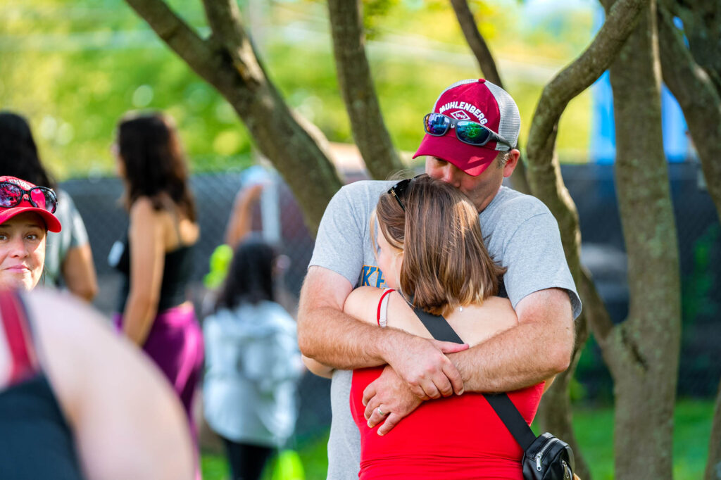 A Muhlenberg College father hugs his daughter during orientation