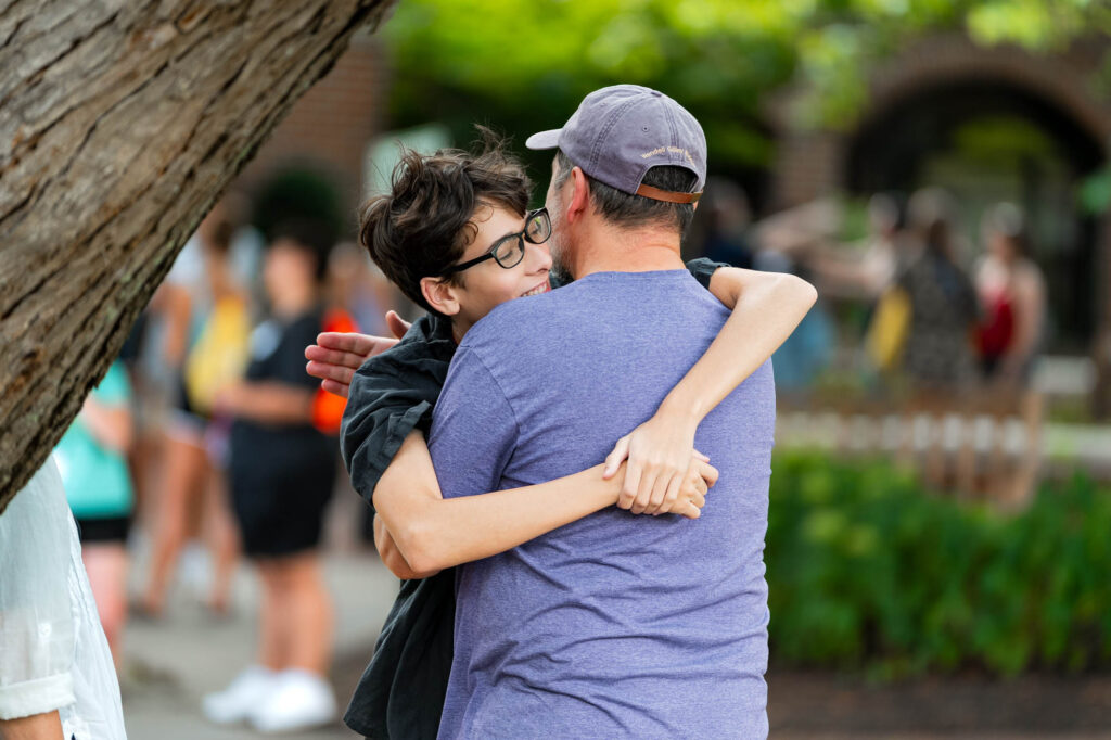 A Muhlenberg College student and father hug during orientation