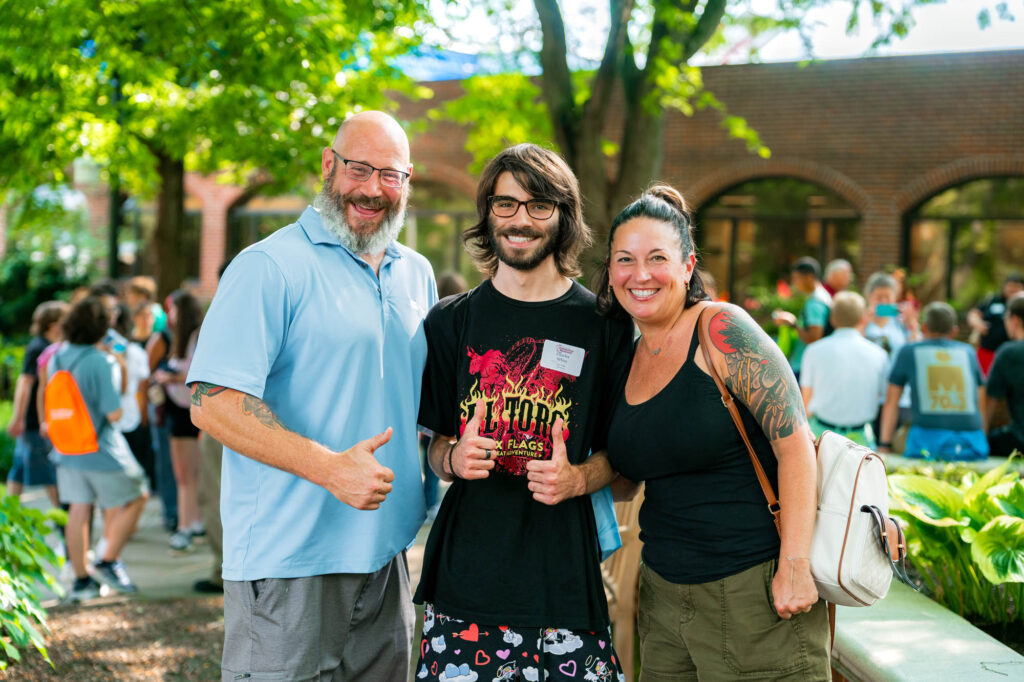 Two Muhlenberg parents and their student pose for a photo during orientation