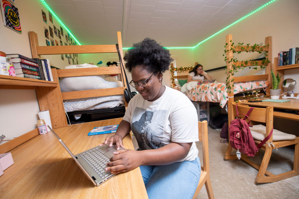 Students chat and study in student housing as part of life on campus