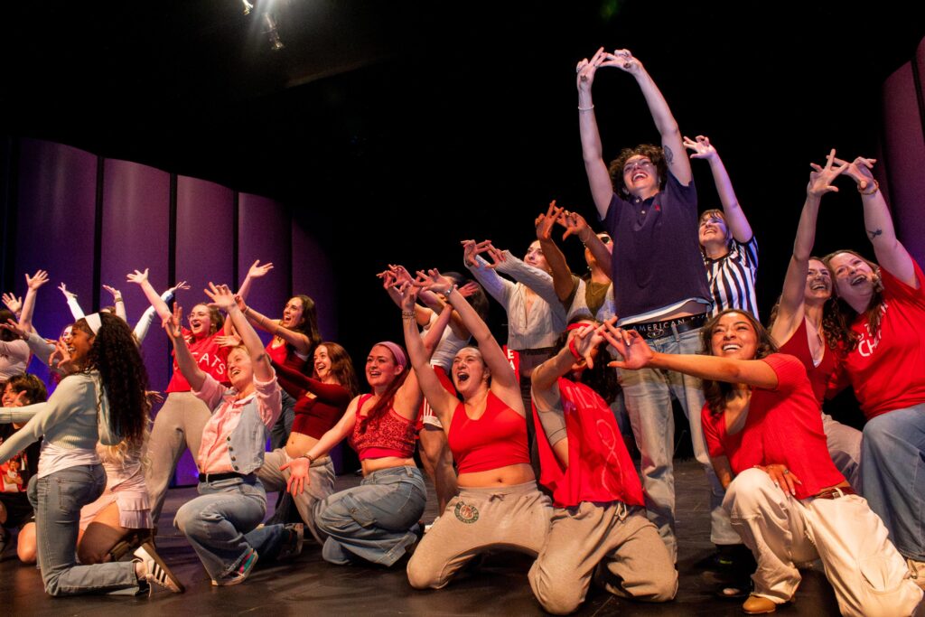 A group of college sorority members pose at the end of a lip synching routine