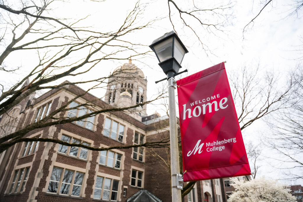 Photo of the Welcome Home pole banners with the Haas building in the background