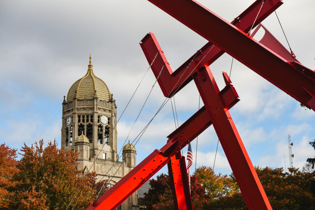 Haas building with the red metal sculpture of victor's lament in the foreground