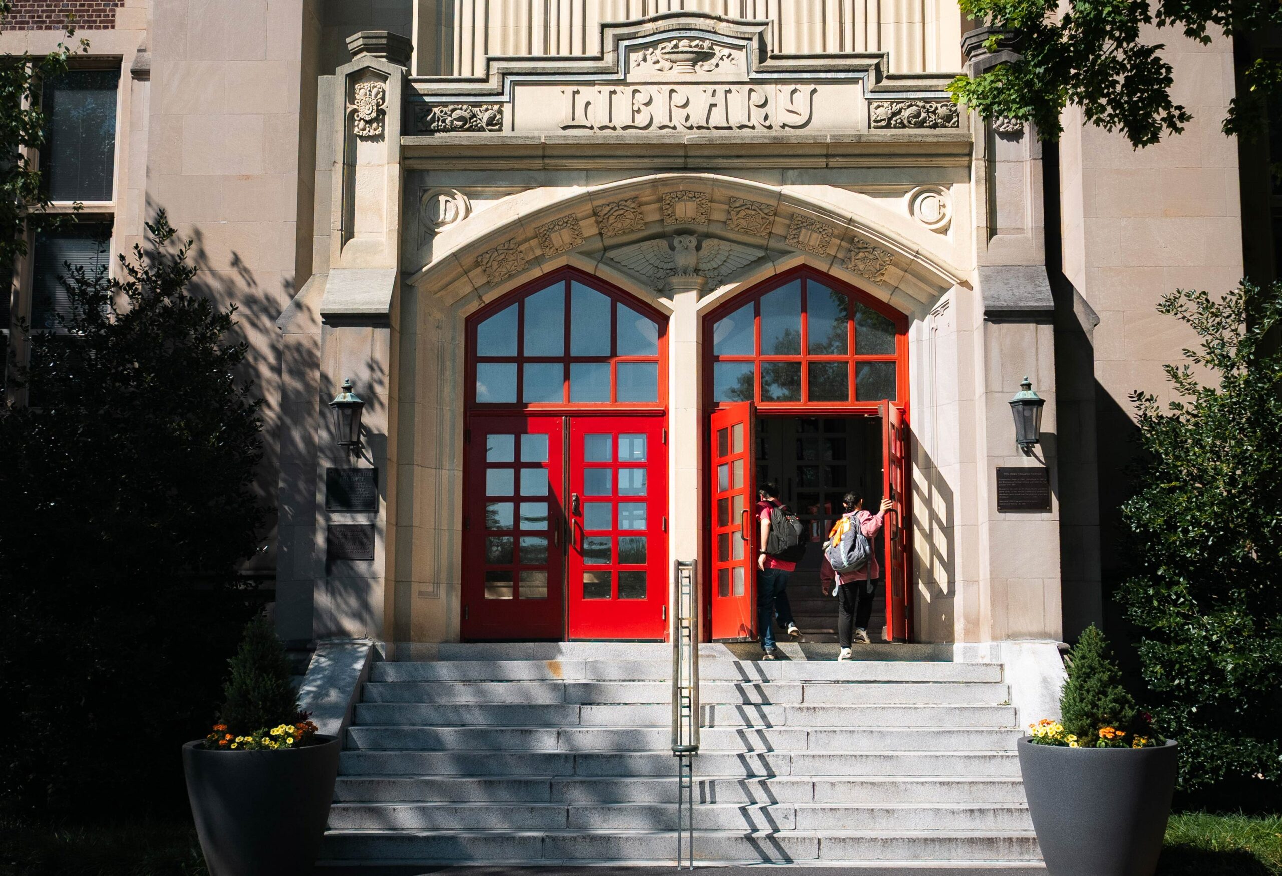 Meet Your Counselor A pair of students walk through the open red doors of Haas College Centre.