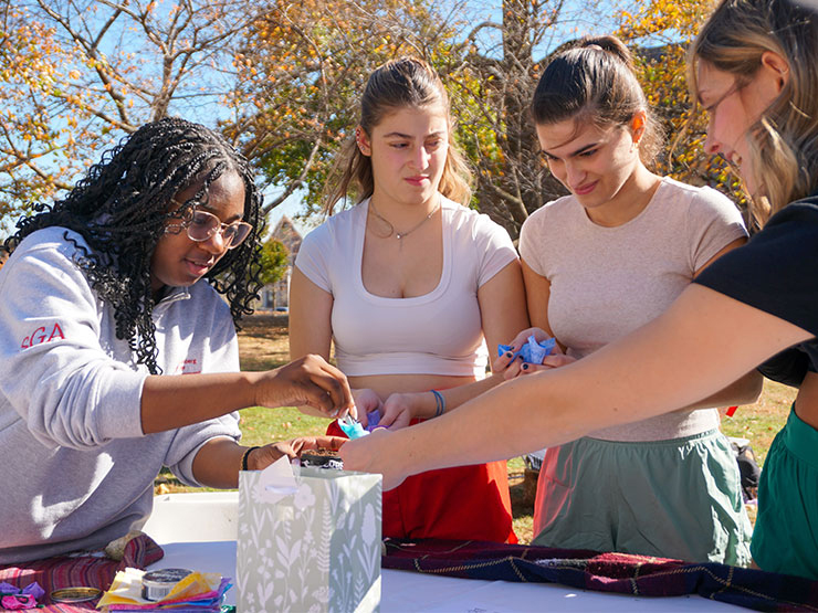 Indigenous Initiatives Muhlenberg students learning to make a tobacco tie during the Hitekw Project opening.