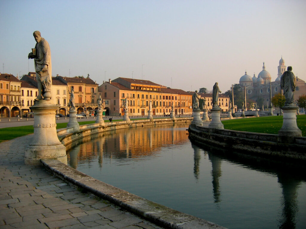 Statutes along the canal at the site of the Prato della Valle in Padua in Italy at sunset