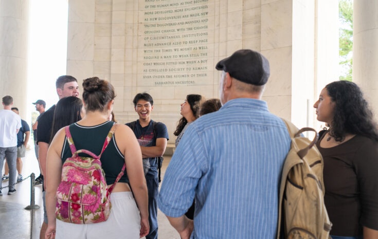 A Muhlenberg RJ Fellow cohort huddles in the Lincoln Memorial in Washington D.C.