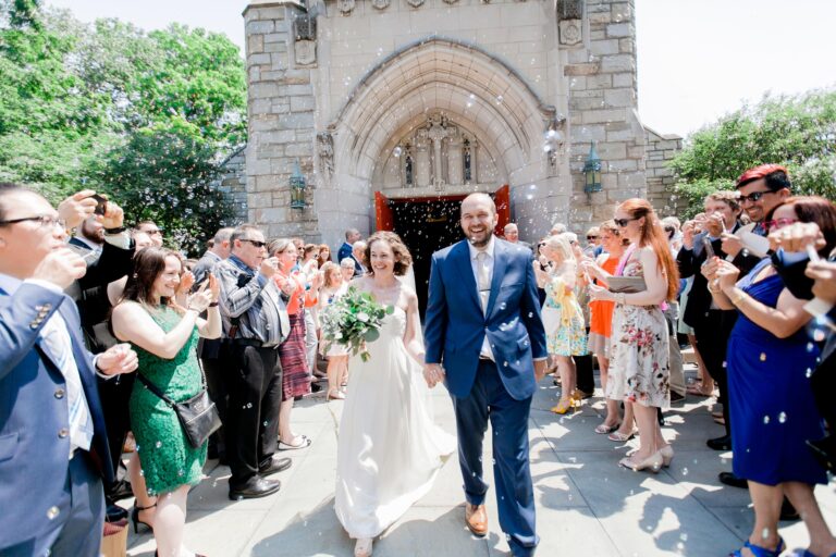 A married couple leaves the church through a cloud of bubbles