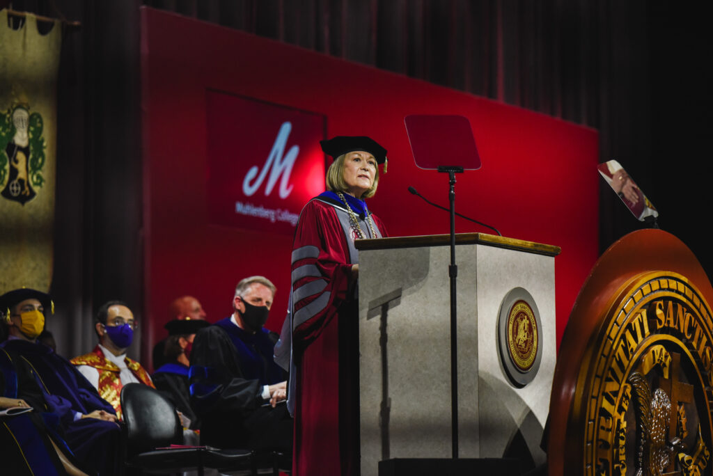 Photo of Kathleen Harring during the inauguration ceremony standing on the stage behind the podium