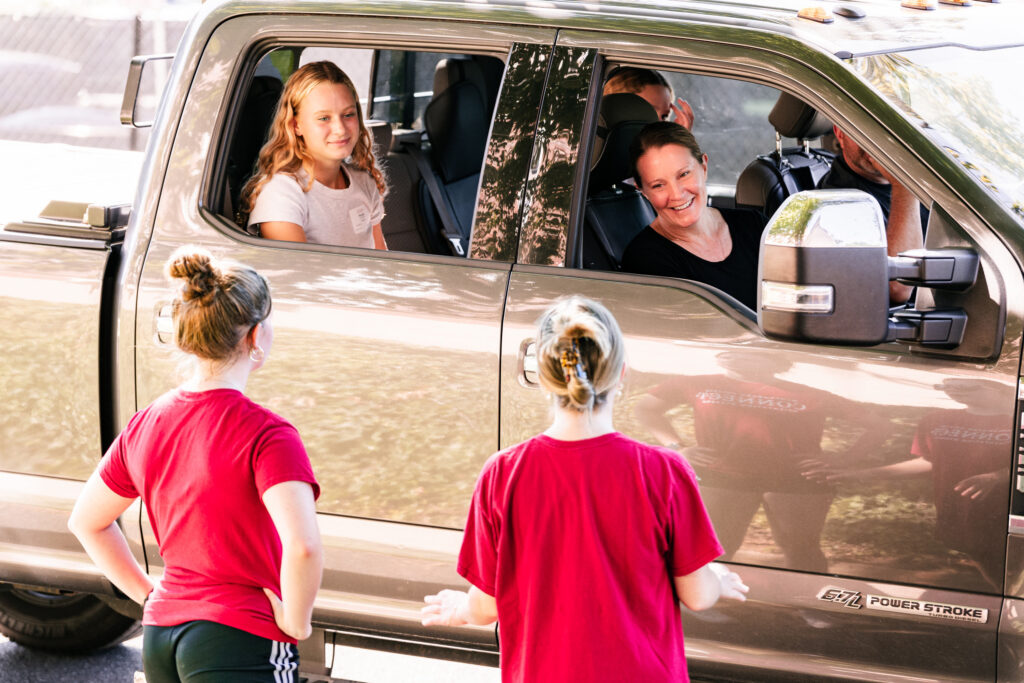 A college student and her parents arrive to move-in day in a pickup truck