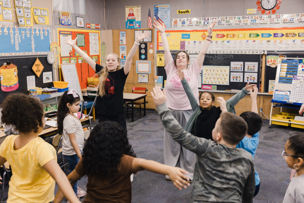 Muhlenberg College students teach a dance to Allentown grade school students.