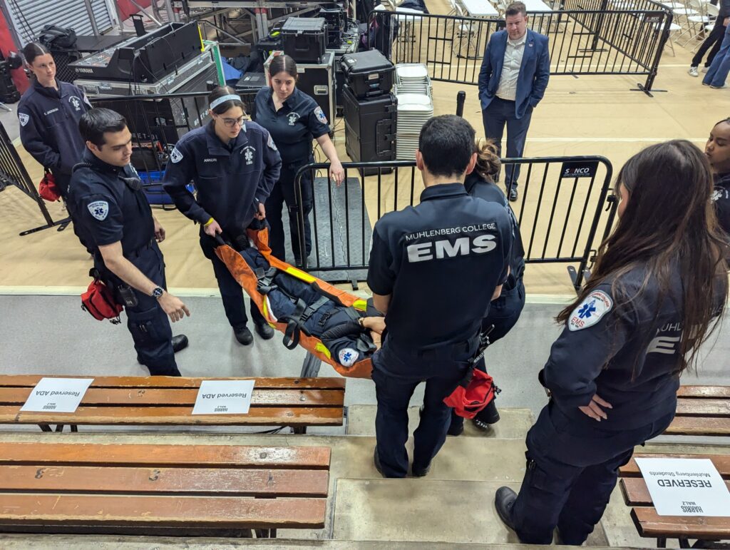 Muhlenberg EMS students carry a stretcher in Memorial Hall.