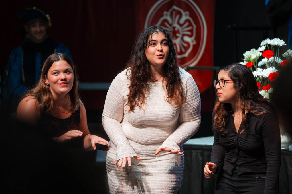 Three Muhlenberg College students sing together